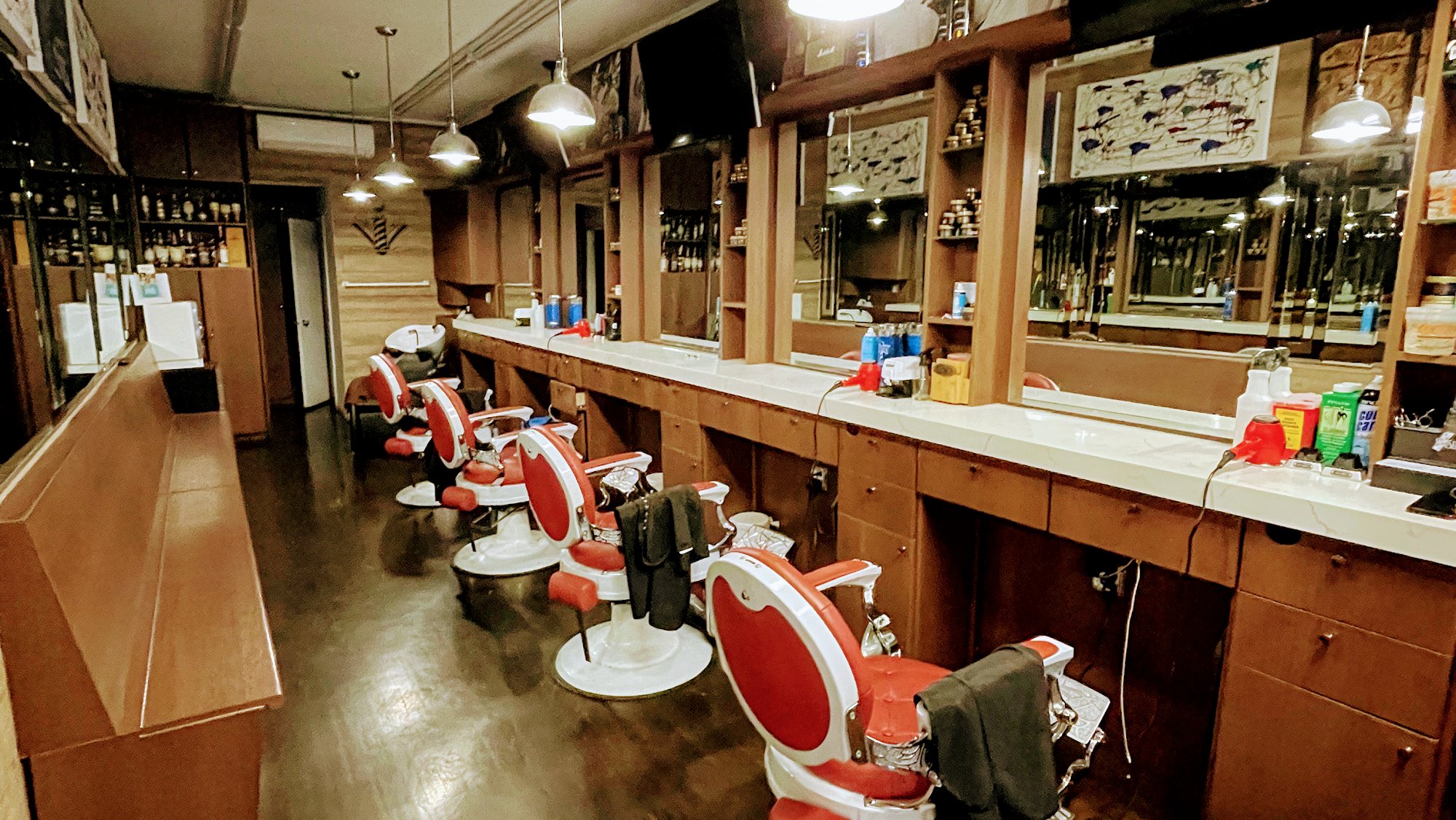 City Barbers NYC barbershop interior — classic chairs and warm atmosphere at 223 E 74th St, Upper East Side